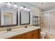Bathroom with double vanity, granite countertop, and a glass door shower at 602 Country Park Se Dr, Smyrna, GA 30080