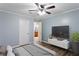 Bedroom with ceiling fan, ensuite bathroom, and ample natural light at 602 Country Park Se Dr, Smyrna, GA 30080