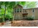 Beautiful exterior view of a home featuring balconies and surrounded by lush, mature trees at 602 Country Park Se Dr, Smyrna, GA 30080