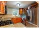 Well-lit kitchen with granite countertops, stainless steel appliances, and warm wood cabinetry at 602 Country Park Se Dr, Smyrna, GA 30080