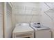 Functional laundry area with washer, dryer, and shelving for storage at 602 Country Park Se Dr, Smyrna, GA 30080