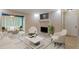 Living room showcasing fireplace, neutral furniture, and sunroom access, creating a cozy ambiance at 602 Country Park Se Dr, Smyrna, GA 30080