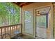Outdoor patio with a view of the beautiful green trees and a glimpse into the house at 602 Country Park Se Dr, Smyrna, GA 30080