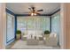 Bright sunroom featuring multiple windows, seating, and a ceiling fan for year-round enjoyment at 602 Country Park Se Dr, Smyrna, GA 30080
