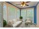Inviting sunroom with ample natural light, comfortable seating, and a tranquil view at 602 Country Park Se Dr, Smyrna, GA 30080