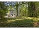 Lush backyard surrounds the home, offering a private and peaceful outdoor oasis immersed in nature's embrace at 1080 Westmont Sw Rd, Atlanta, GA 30311