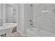Bright bathroom featuring marble tiles, soaking tub, new fixtures, and pedestal sink at 1080 Westmont Sw Rd, Atlanta, GA 30311