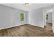 Bright bedroom with modern gray walls, wood-look flooring and a window with natural light at 1080 Westmont Sw Rd, Atlanta, GA 30311