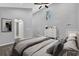 Bright bedroom featuring a ceiling fan, window, and a white dresser with black pulls at 1080 Westmont Sw Rd, Atlanta, GA 30311