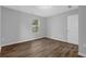 Bedroom featuring wood-look flooring, closet and a window offering natural light at 1080 Westmont Sw Rd, Atlanta, GA 30311