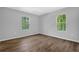 Bedroom featuring wood-look flooring, and two windows offering natural light at 1080 Westmont Sw Rd, Atlanta, GA 30311