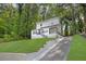 Charming two-story home with white siding, dark railings, and a beautifully landscaped yard at 1080 Westmont Sw Rd, Atlanta, GA 30311