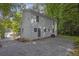 Two story home with white siding and stone landscaping in backyard at 1080 Westmont Sw Rd, Atlanta, GA 30311