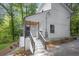 Charming two-story home with white siding, dark railings, and a inviting front entry at 1080 Westmont Sw Rd, Atlanta, GA 30311