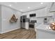 Modern kitchen with stainless steel appliances, white cabinets, and wood flooring at 1080 Westmont Sw Rd, Atlanta, GA 30311