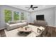 Cozy living room featuring a neutral sofa, wood floors, and large windows that let in ample light at 1080 Westmont Sw Rd, Atlanta, GA 30311