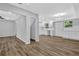 Open floor plan with gray walls and wood-look floors connecting the living area and modern kitchen at 1080 Westmont Sw Rd, Atlanta, GA 30311