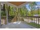 Inviting porch with wood railings offers views of the surrounding trees and neighborhood at 1080 Westmont Sw Rd, Atlanta, GA 30311