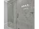 Bathroom shower featuring marble tiling, glass door, and modern fixtures at 1080 Westmont Sw Rd, Atlanta, GA 30311