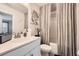 Clean bathroom with a white vanity, large mirror, and shower with neutral shower curtain at 265 Riverclub Rd, Acworth, GA 30101