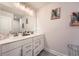 Bright bathroom features double sinks with white cabinetry and modern fixtures and neutral paint at 265 Riverclub Rd, Acworth, GA 30101