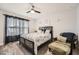 Cozy bedroom featuring a ceiling fan, patterned bedding, and comfortable seating area at 265 Riverclub Rd, Acworth, GA 30101