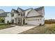 Charming home showcases traditional design, a well-manicured lawn and a two-car garage at 265 Riverclub Rd, Acworth, GA 30101