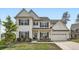 Beautiful two-story home boasts traditional design, a blue front door, lush lawn and a two-car garage at 265 Riverclub Rd, Acworth, GA 30101