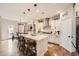 Modern kitchen features an island with seating, stainless appliances and sleek white cabinets at 265 Riverclub Rd, Acworth, GA 30101