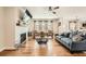 The living room is bright with a fireplace, sleek ceiling fan and plenty of comfortable seating at 265 Riverclub Rd, Acworth, GA 30101
