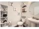 Well-decorated powder room with floating shelves, white fixtures, and modern accessories at 265 Riverclub Rd, Acworth, GA 30101
