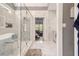 Modern bathroom featuring marble tile, glass shower, and a neutral color palette at 4835 Liberty Rd, Villa Rica, GA 30180