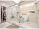 Modern bathroom with white marble walls, glass shower, soaker tub, and open closet at 4835 Liberty Rd, Villa Rica, GA 30180