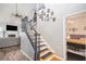Bright foyer with staircase, hardwood floors, and view into the living room with a fireplace and large TV at 4835 Liberty Rd, Villa Rica, GA 30180