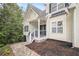 Inviting front entrance featuring a charming porch, decorative wreath, and beautiful stone accents around the door at 4835 Liberty Rd, Villa Rica, GA 30180