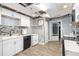 Kitchen featuring white cabinets, a mosaic backsplash, and wood-look floors at 4835 Liberty Rd, Villa Rica, GA 30180
