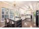 Open-concept kitchen and dining area with dark wood floors and lots of natural light at 4835 Liberty Rd, Villa Rica, GA 30180