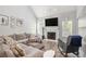 Spacious living room with a cozy fireplace, hardwood floors, and lots of natural light from the surrounding windows at 4835 Liberty Rd, Villa Rica, GA 30180