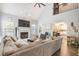 Open concept living room with a fireplace, large sectional sofa, and view into the kitchen and upper level at 4835 Liberty Rd, Villa Rica, GA 30180