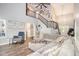 Bright living room with a staircase, large sectional sofa, and view into the dining room, illuminated by natural light at 4835 Liberty Rd, Villa Rica, GA 30180