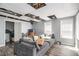 Spacious living room with wood-look flooring, large grey sofa, and natural light from the window at 4835 Liberty Rd, Villa Rica, GA 30180