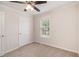 A bedroom with neutral carpet, ceiling fan, and a window offers a simple, clean, and inviting space at 5975 Tate Dr, Austell, GA 30106