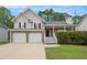 Charming two-story home featuring a two-car garage, stone accents, and a welcoming front porch at 5975 Tate Dr, Austell, GA 30106