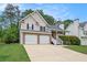 Charming two-story home featuring a two-car garage, stone accents, and a welcoming front lawn at 5975 Tate Dr, Austell, GA 30106