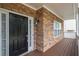 Close-up of the front door showcasing stone accents, covered porch, and a modern black door at 5975 Tate Dr, Austell, GA 30106