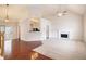 Spacious living room with a fireplace, hardwood floors, carpet, and an open view to the kitchen at 5975 Tate Dr, Austell, GA 30106