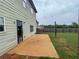 Backyard features a concrete patio, green grass, wooden fence, and access to the home at 2166 Villa Spring Ct, Dacula, GA 30019