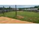 View of the backyard showing a large grassy area with a wooden fence and an outdoor patio at 2166 Villa Spring Ct, Dacula, GA 30019