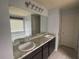 Bathroom with granite countertop, dual sinks and large mirror and dark brown cabinets at 2166 Villa Spring Ct, Dacula, GA 30019