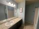 Bathroom with large mirror, granite counters and blue paint at 2166 Villa Spring Ct, Dacula, GA 30019